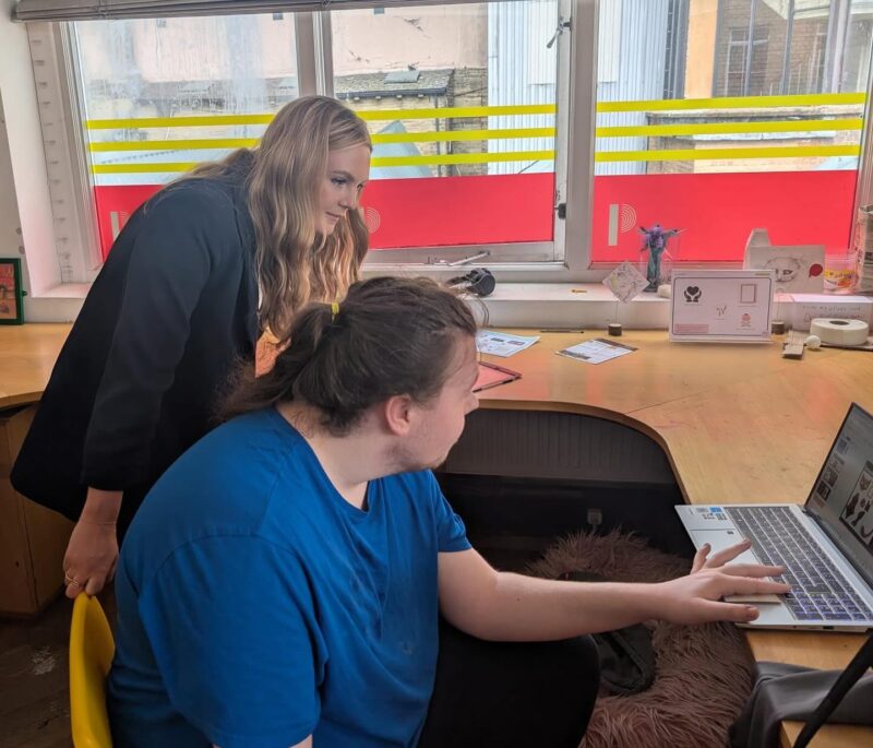 Kate Dearden MP looking at student work